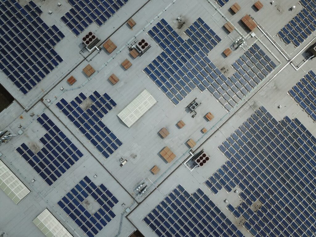 Drone shot of solar panels covering a building rooftop in Farmington, MN, showcasing renewable energy efforts.